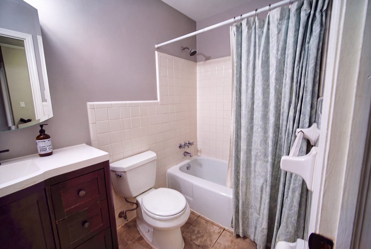Third full bathroom with vanity, tub/shower combo, and tile floor