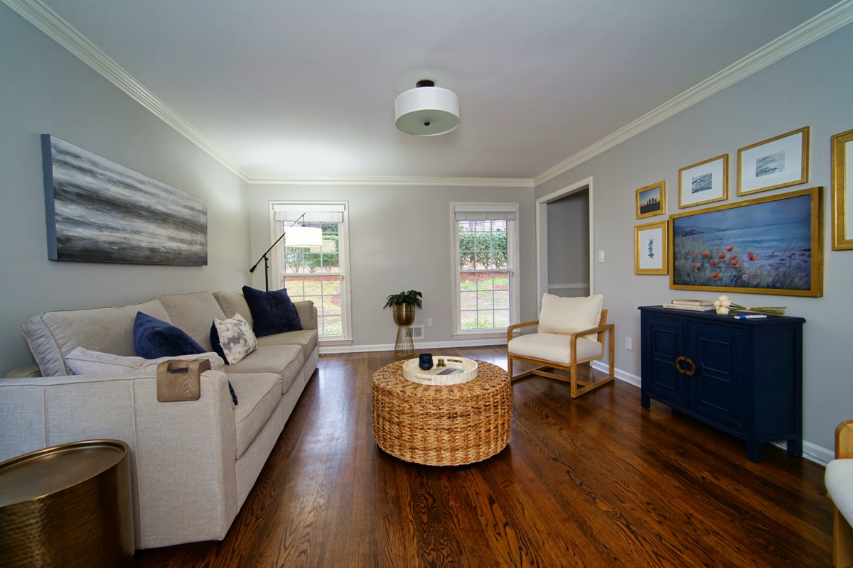 Living room view showing windows, hardwood floors, and elegant furnishings