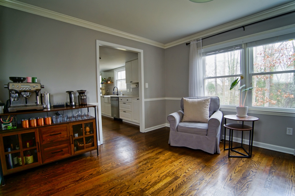 Sitting room with espresso bar, hardwood floors, and view into kitchen